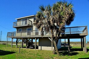 Enjoy stunning ocean views from the upper-level balcony of this beachfront property.