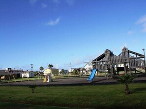 Children can play on the playground's slide and climbing structure.