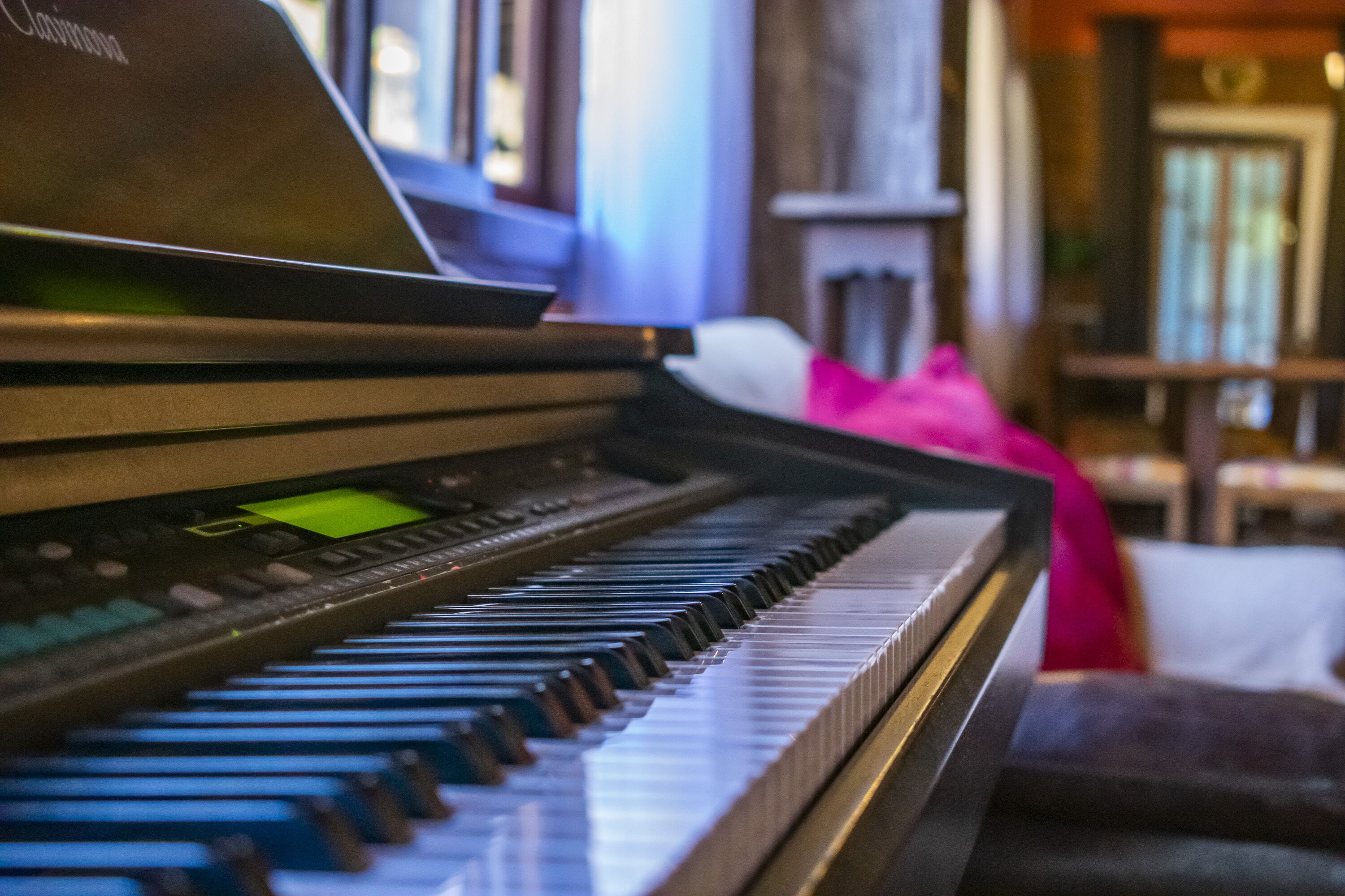 A close-up of a piano keyboard with a digital display and control panel.