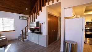 A modern kitchen with a refrigerator, oven, and a trash can. - Moon Creek, A lovely Cabin that is located in the Pinetop Country Club Community (Pinetop)