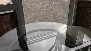 A room with a glass table and a view of the beach and ocean through large windows. - Oceanfront condo, beach, pool. 4 eateries on premises. Rent kayaks and jet skis. (Fort Lauderdale)