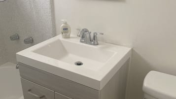 Combined shower/bathtub, hair dryer, towels, soap