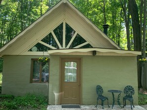 A small, single-story building with a sloped roof and a door.