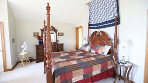 A four-poster bed with a quilt, a wooden dresser, a mirror, and a bedside table with a lamp. - Table Rock Lake, Steps to Marina (Holiday Island)