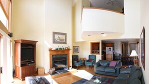 A spacious living room with a fireplace, a television, and comfortable seating. - Table Rock Lake, Steps to Marina (Holiday Island)
