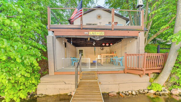 A dock leading to a building with a sign reading "Lake & Easy." - Lakefront Family Retreat w/ Private Dock! (Rice Lake)