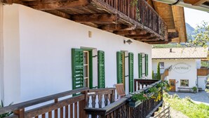 Un edificio con balcones de madera, contraventanas verdes y un letrero que dice 'Am Waal'.