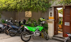 A motorcycle parked in front of a building with a sign reading '29' and 'Coning Ayu.' - Cening Ayu Sanur (Denpasar)