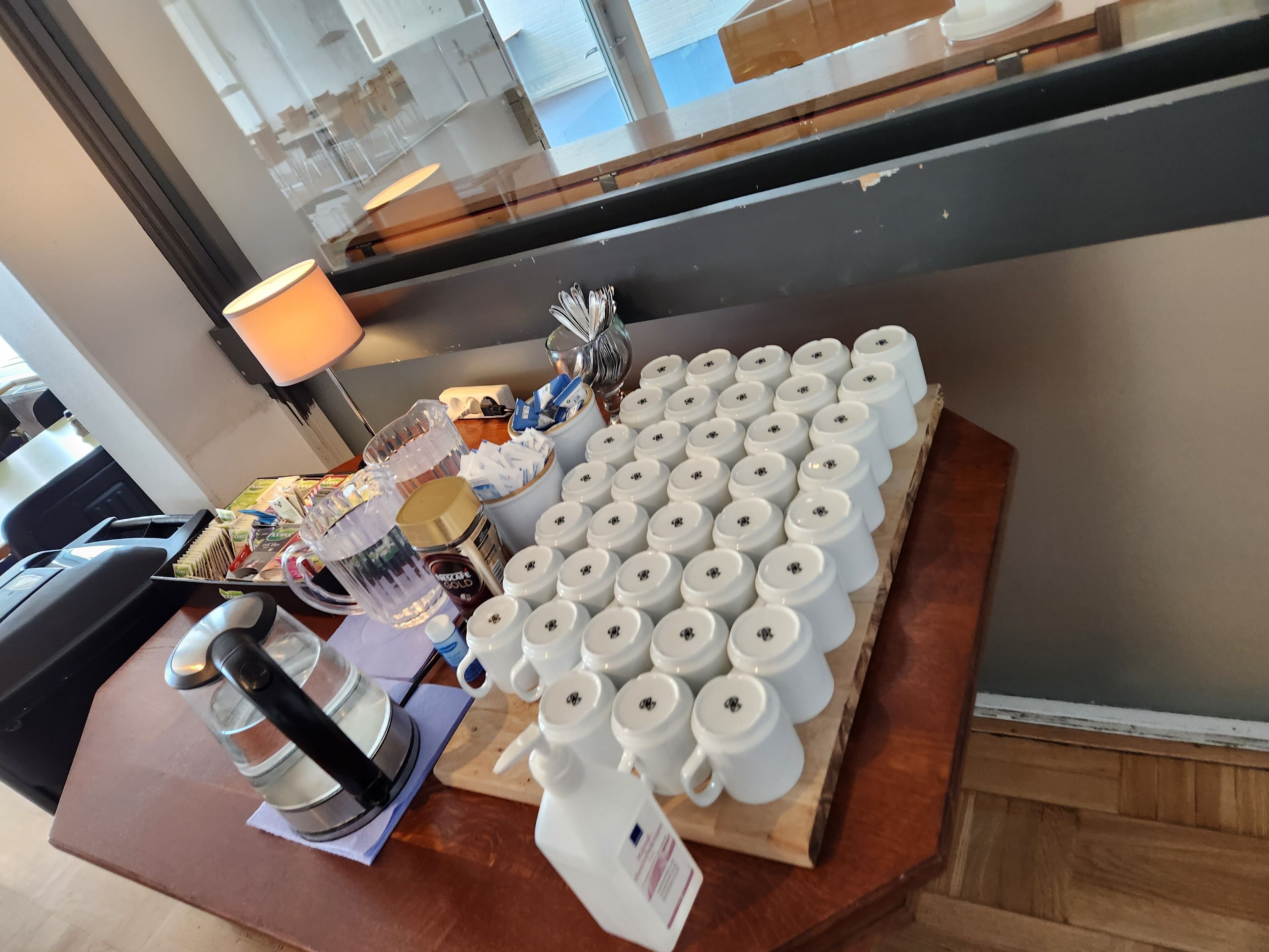 A coffee station with multiple coffee cups, a coffee machine, and various coffee-related items.