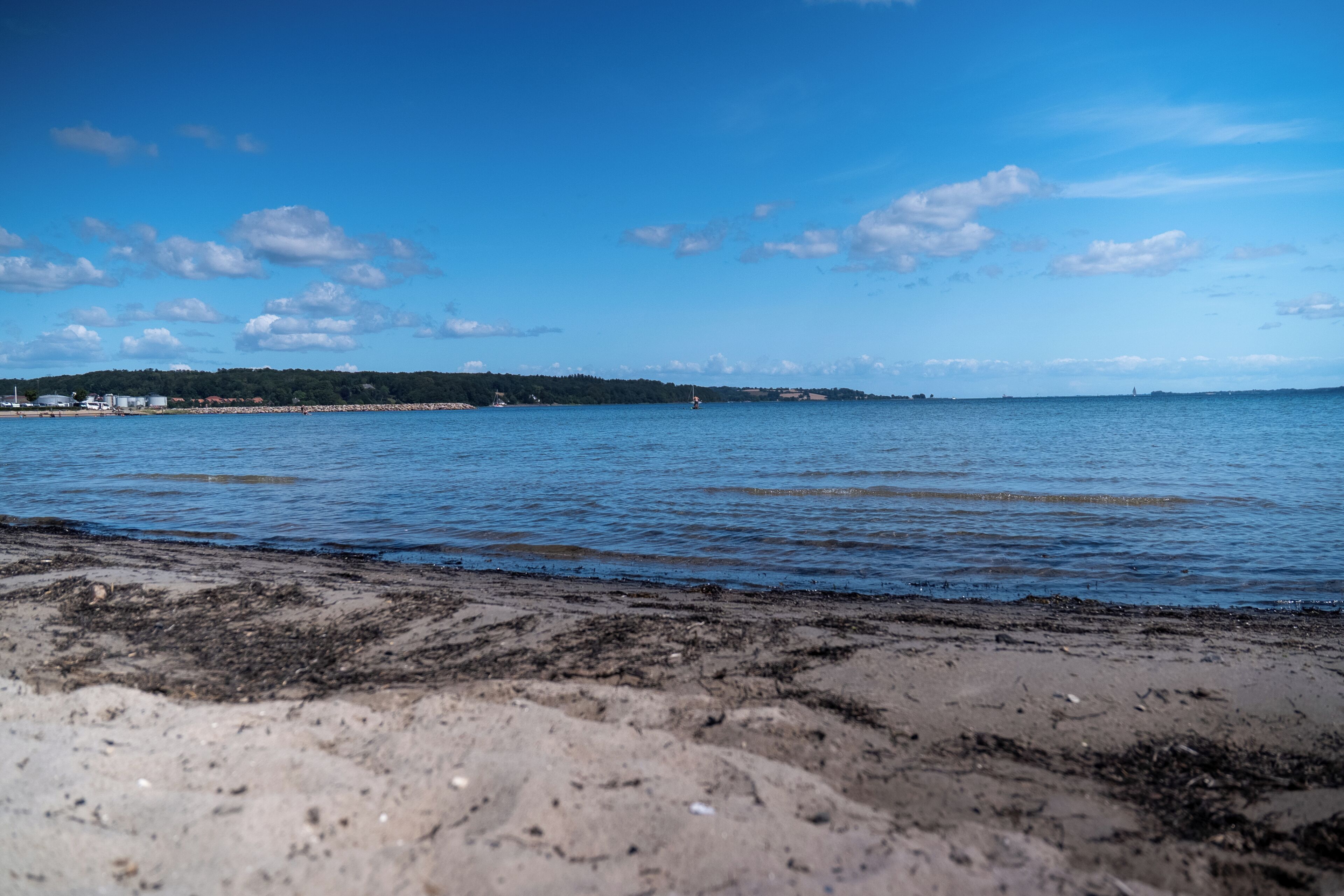 A beach with clear skies and calm water.