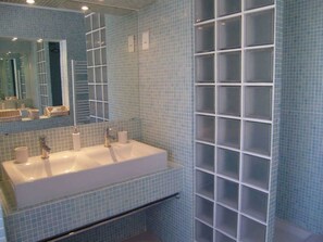 Bathtub, bathrobes, slippers, towels