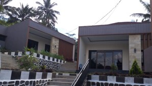 A modern building with a stone staircase leading to a gated entrance. - Oase Van Java (Gedong)