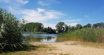 Holiday house with a large garden and swimming lake in the village