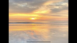 A beach with a sunset over the ocean. - New Build • Walk to the beach• Bikes • Beach Toys! (St. Augustine)