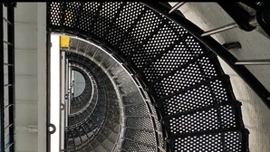 A spiral staircase with black metal railings and perforated steps. - New Build • Walk to the beach• Bikes • Beach Toys! (St. Augustine)