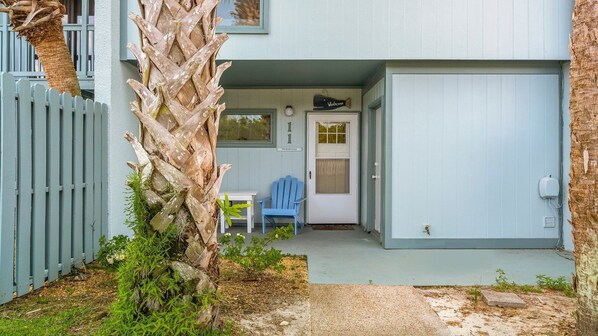 A house with a porch, a blue chair, and a door labeled "Our Beach House". - Unit 11, Anchors Away, 2 Bedroom Beach Condo (Panama City Beach)