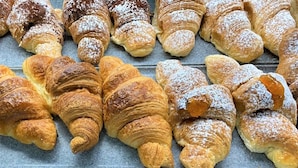 A variety of pastries, including croissants and other baked goods, arranged on a tray. - Hippocampus B&B (Giardini Naxos)