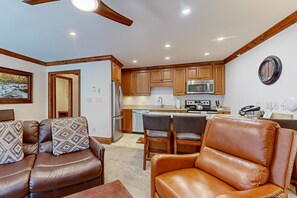 Relax in a stylish living space with a cozy seating area and modern kitchen.