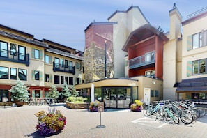 Experience the hotel's modern design, surrounded by a tranquil courtyard with potted plants and bike-friendly amenities.