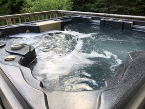 Hot tub on deck overlooking backyard