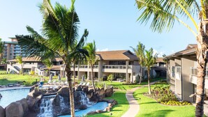 A resort with a swimming pool, palm trees, and a waterfall. - KLVR welcomes you to Honua Kai Luana 11C Oceanfront Resort Resort and POOL view  (Lahaina)