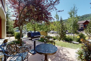 Enjoy al fresco dining on the patio, surrounded by lush gardens and a scenic mountain view.