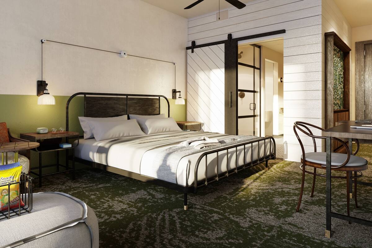 Ein modernes Schlafzimmer mit Bett, Nachttischen, Schreibtisch und Stuhl.