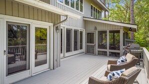 A covered deck with wicker furniture and a grill. - 5 ⭐️ property! Private pool!!SHORT walk to beach!! ❤️ of Sea Pines. Sleeps 12 (Hilton Head Island)