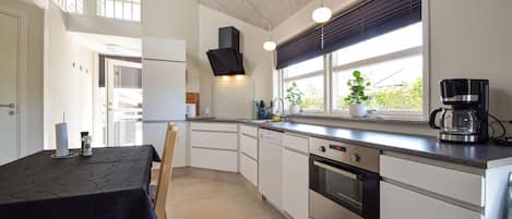 Fridge, stovetop, dishwasher, coffee/tea maker