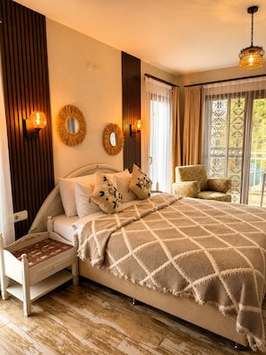 A bedroom with a bed, bedside tables, a chair, a mirror, and a window with curtains. - Mai S'ema Otel Dalyan (Cesme)