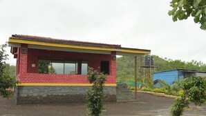 Un pequeño edificio de una sola planta con fachada de ladrillo rojo y tejado amarillo.