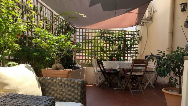 A patio with wicker furniture, a table, and chairs. - 2-room apartment for 2 people close to Moure Rouge beach. (Cannes)