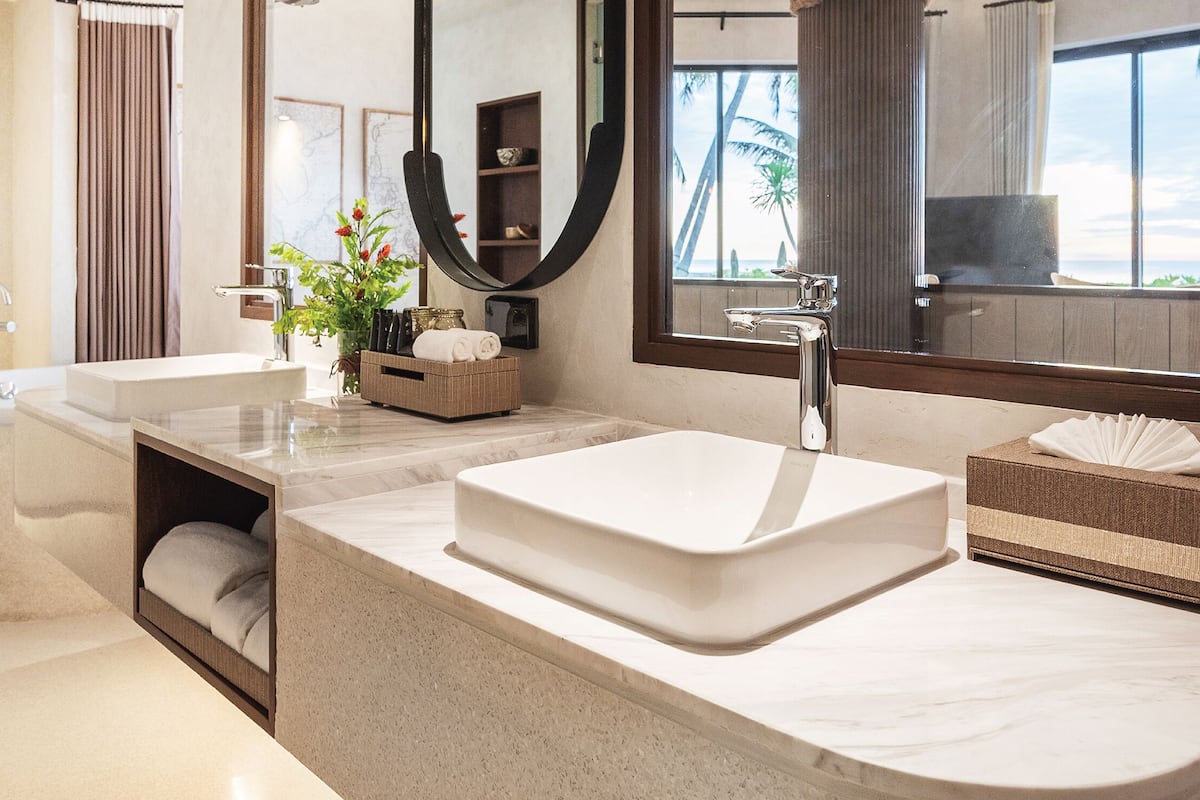 pool villa beach front | bathroom | designer toiletries, hair dryer, bathrobes, slippers