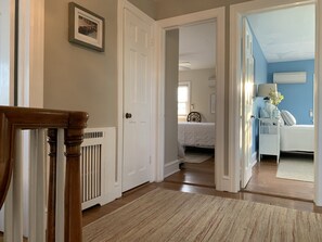 Enter a serene bedroom with a comfortable bed, nightstand, and lamp.