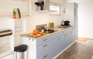 Fridge, microwave, coffee/tea maker, cookware/dishes/utensils