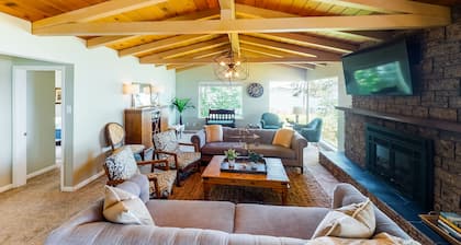 Inviting bayside dwelling with beach access, deck, waterfront views, & fireplace