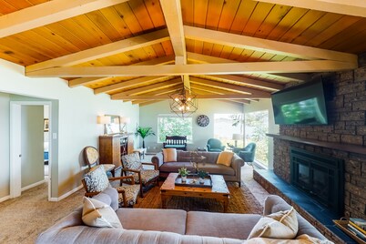 Inviting bayside dwelling with beach access, deck, waterfront views, & fireplace