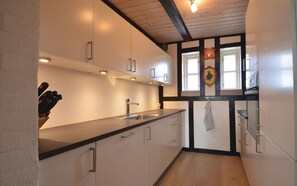 Fridge, stovetop, dishwasher, coffee/tea maker