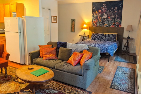 Seating area with queen bed. The couch is a double sleeper sofa.