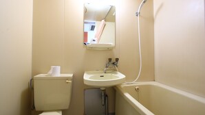 A small bathroom with a toilet, sink, and shower. - Hotel New Nishida (Tokunoshima)