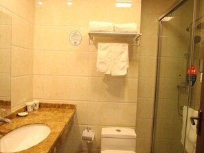 A bathroom with a marble sink, a toilet, and a glass shower enclosure. - Greentree Inn Linyi Yitang Town Shuangling Road Ex (Linyi)