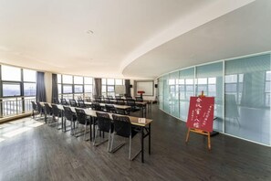 Une salle de conférence avec une longue table, des chaises et un tableau blanc.