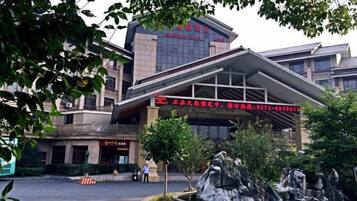 A building with a modern architectural design, featuring a prominent entrance with a red sign.