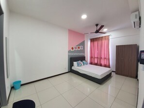 Relax in this serene bedroom with a large bed, ceiling fan, and stylish window.