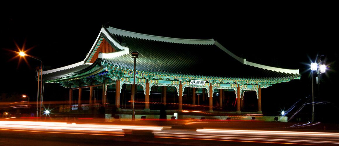 A traditional building with a curved roof and multiple columns.