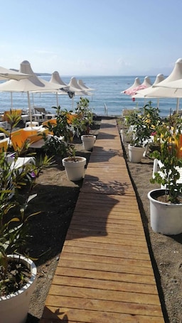 Private beach, black sand, free beach cabanas, sun loungers. Yahsi Beach Hotel