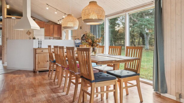 A modern kitchen with wooden cabinets, a central island, and pendant lighting. - Stunning home in Fjerritslev with WiFi (Fjerritslev)