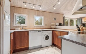 Enjoy cooking in this well-equipped kitchen with dishwasher and ample countertop space.