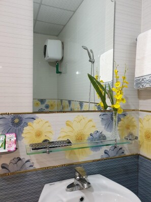 Shower, hair dryer, slippers, towels