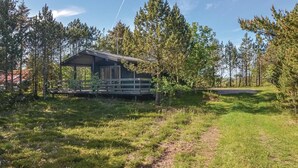 A cabin with a covered porch and a dirt path leading to it, surrounded by trees. - Amazing home in Hurup Thy with WiFi (Hurup Thy)